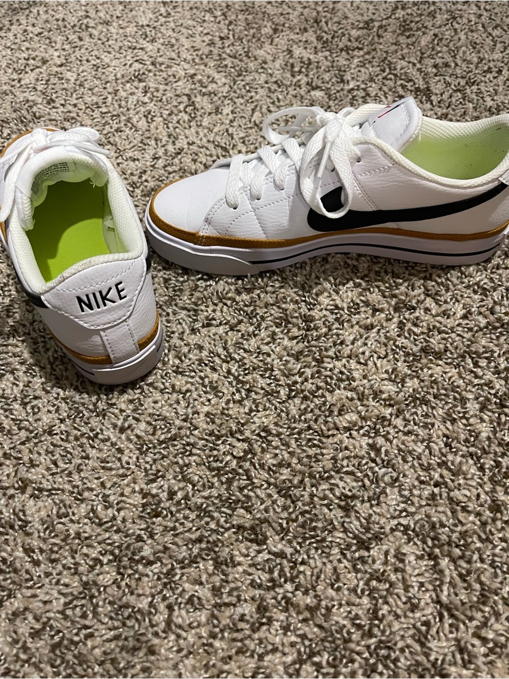 Nike White Low-Top woman’s Sneakers with Black Swoosh and Gold Trim